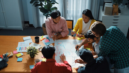 Top down view of smart business team in casual cloth brainstorming marketing idea and writing mind map together. Professional creative people using mind map to share and exchange idea. Convocation.