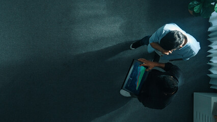 Top down view of manager walking to investor while holding tablet and looking at financial...