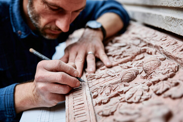 Obraz premium Prague copper art restoration process with artisan hands working on detailed medieval scene