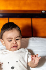baby crying with anger in a bed