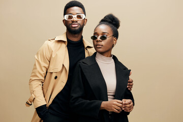 Fashionable African models posing in stylish sunglasses, showcasing modern trends against a warm,...