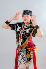 A young Indonesian woman in a traditional Jathilan costume poses with an 