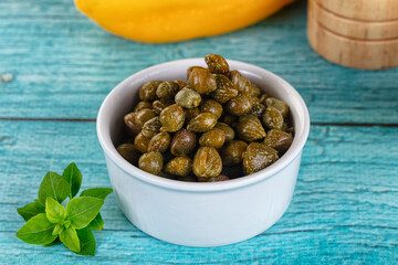 Pickled canned capers in the bowl