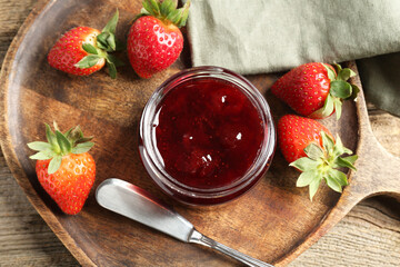 Delicious strawberry sauce and fresh berries on wooden table, flat lay