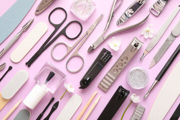 Set of different manicure tools on pink background, flat lay