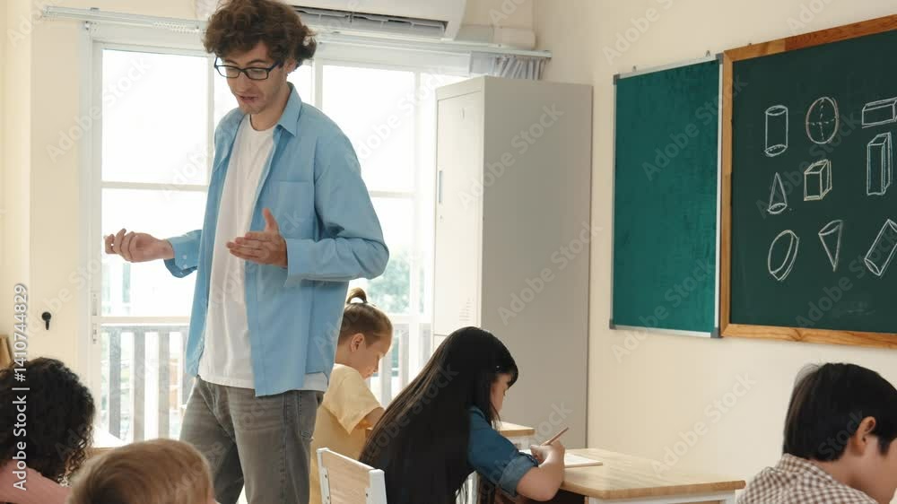 Poster skilled teacher walking at classroom while looking at student homework. professional instructor chec