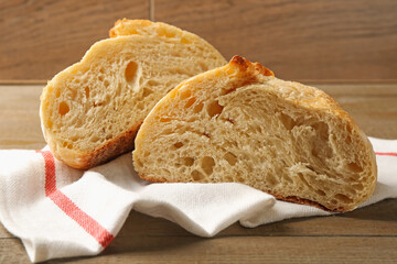Slices of fresh bread on wooden table, closeup