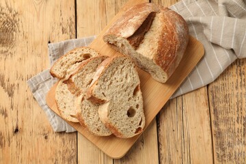 Pieces of fresh bread on wooden table, top view