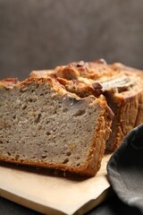 Cut banana bread with nuts on table, closeup