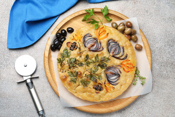 Delicious focaccia with flowers made of vegetables and cutter on grey table, top view