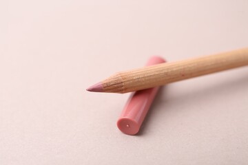 One beautiful lip pencil on light background, closeup