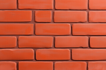 Obraz premium Close-up shot of a textured red brick wall, capturing its intricate details. The bricks are arranged in a classic pattern, creating a robust and durable aesthetic