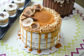 Assorted Cakes and Desserts on Display include caramel cake with fig slices, a chocolate cake with sprinkles, and layered dessert cups closeup side view of sweet treats