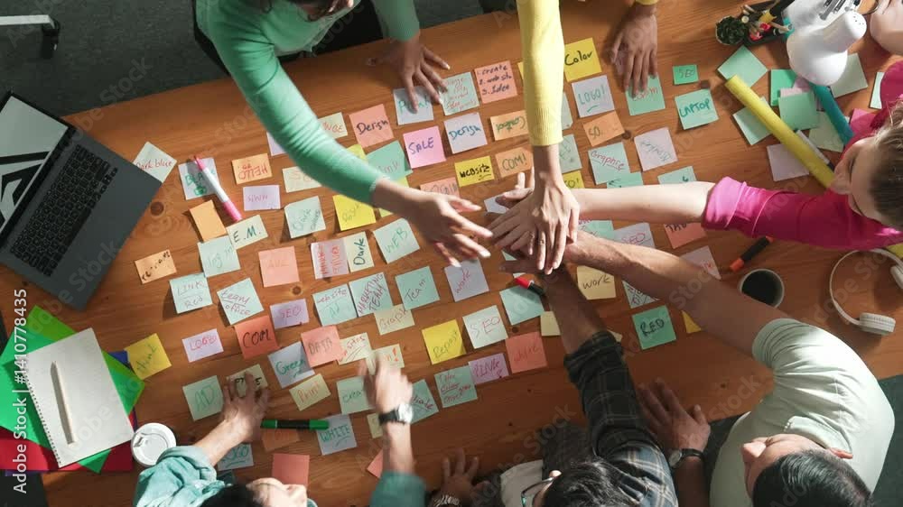 Poster top down view of designer standing at meeting with sticky note and putting hand together. aerial vie
