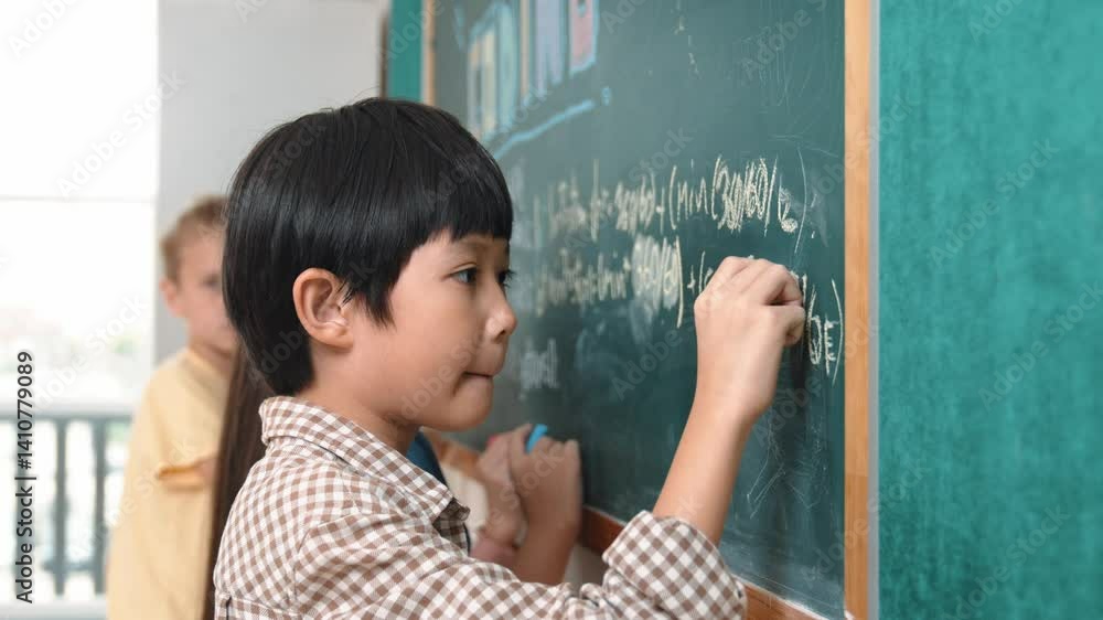 Poster side view of asian boy writing engineering prompt and programing system while standing blackboard wi