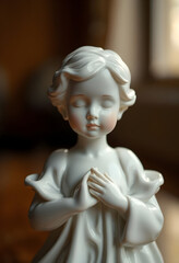white porcelain figurine of a young girl praying