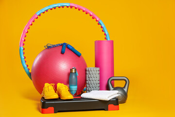 Many different fitness equipment on orange background © New Africa