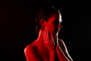 Photo of attractive sexy young woman touch skin look empty space neon red light shoulders off on black color background