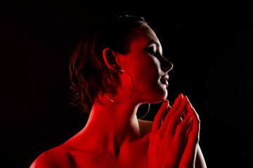 Photo of gorgeous sexy young female soft silky skin neon red light dressed trendy dress on black color background