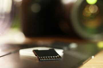 SD memory cards, holder and laptop on table, closeup