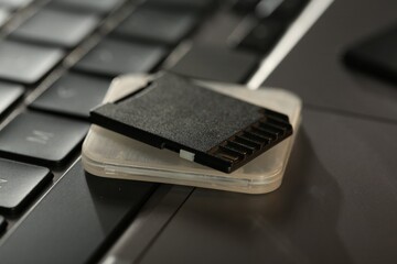 SD memory card and holder on laptop, closeup