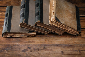 Many old books on wooden table, space for text