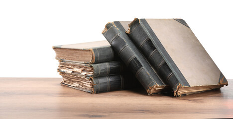 Old books on wooden table against white background