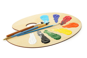 Wooden palette with paints and brushes isolated on white