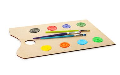 Wooden palette with paints and brushes isolated on white