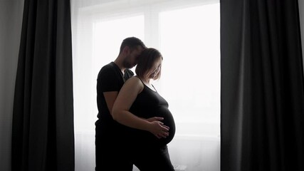 happy pregnant couple together at home. Future parents expressing protection, love and gentle to their future baby. maternity and pregnancy care. hands of a man and a woman on a pregnant belly  - Powered by Adobe