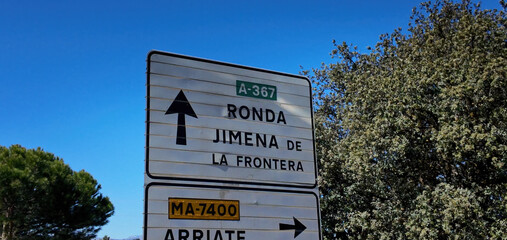 Road signs indicating Ronda and Jimena de la Frontera in Andalusia, Spain