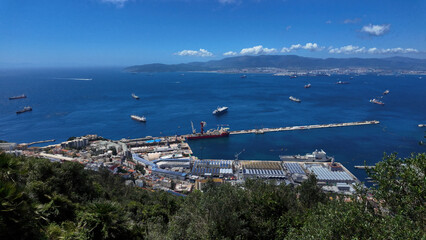 Gibraltar harbor, city and bay embracing cargo ships sailing in the Mediterranean Sea