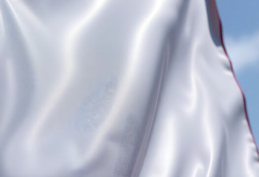 close up of a white flag with a blue sky in the background