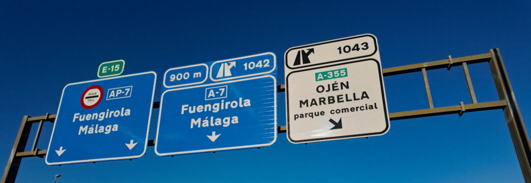 Highway signs showing directions to Fuengirola, Malaga, Marbella and Ojen in Spain