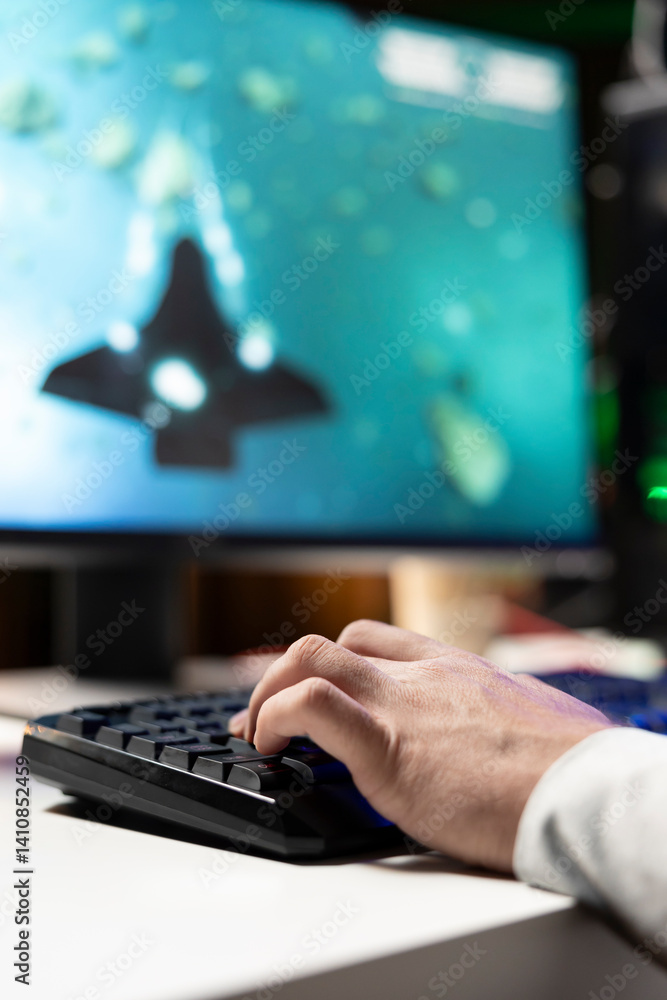 Aufkleber man using gaming keyboard to fly spaceship in sf videogame, close up. player using powerful pc and c