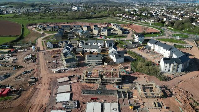 Paignton, South Devon, England: DRONE VIEWS: A new build housing development under construction on green belt land at White Rock. Paignton is a popular UK holiday resort and retirement area (Clip 6).