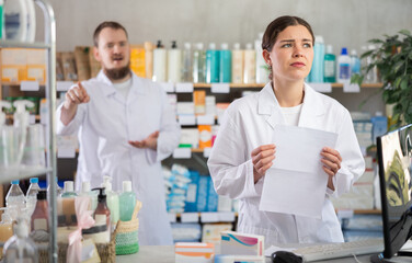 Toxic atmosphere in work collective. Girl pharmacist with resignation letter is attacked by boss....