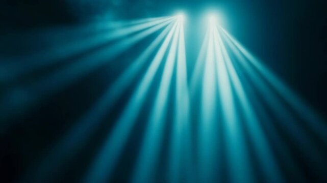 Abstract blue spotlights shining upwards in the dark, beams of light through hazy mist, bright glowing rays illuminate atmosphere