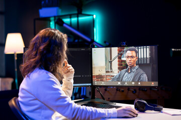 Computer science teacher doing online tutoring, telling student in online videocall about ways to...