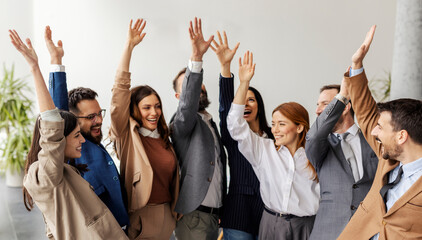 Group of professional businesspeople celebrating success at corporation.
