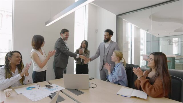 A skilled team celebrates their success in closing a significant business deal in a sleek conference room, highlighting the importance of teamwork and collaboration throughout the process