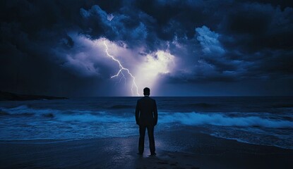 Silhouetted man faces stormy ocean, lightning striking