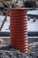 A large plastic fitting protruding from the ground.
