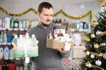 Happy man shopping for Christmas presents at home goods store