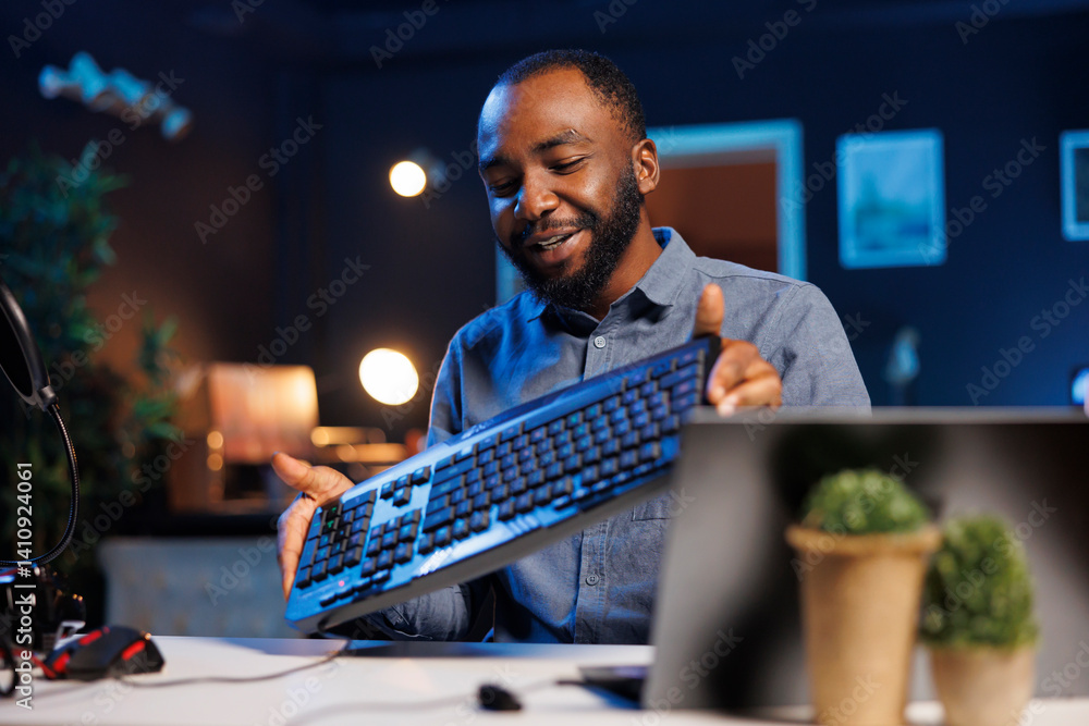 Poster content creator filming keyboard review in personal studio, pressing different buttons to show typin
