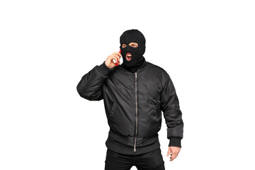 Masked criminal shouting on phone wearing black clothes