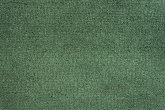 Recycled grunge dark green corrugated cardboard craft background for eco projects. Rough parcel box empty space, sheet of recycled paper for mock up, scrapbook, card, banner. Sustainable packing.