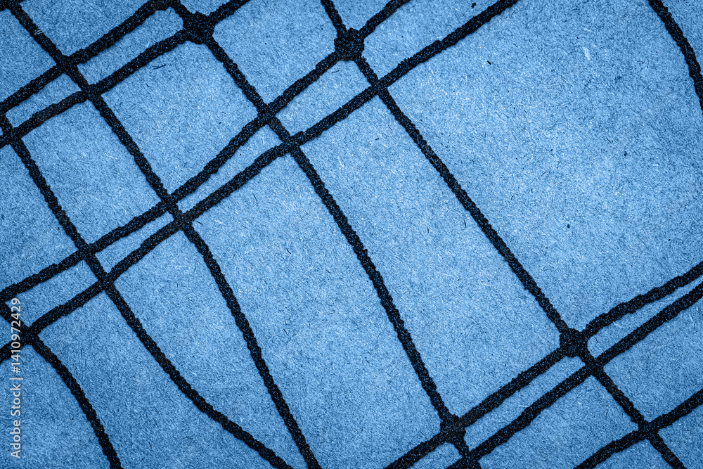 Poster a textured blue surface features a dark grid pattern, showcasing contemporary design elements common