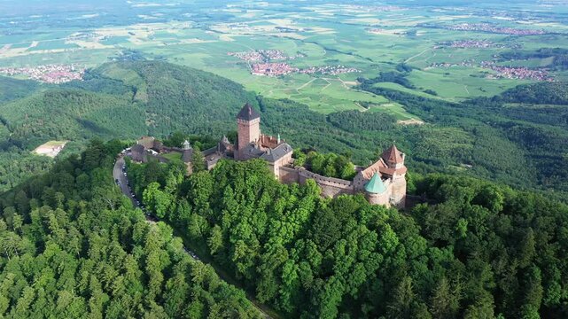 The Haut-Koenigsbourg Castle stands in a forest dominated by the countryside, in Europe, in France, in Alsace, in the Bas Rhin, near Strasbourg, in summer, on a sunny day.&nbsp;