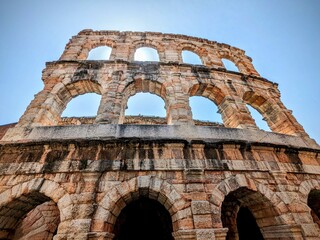 Facade of ancient colosseum on a beautiful sunny day in Verona Italy.